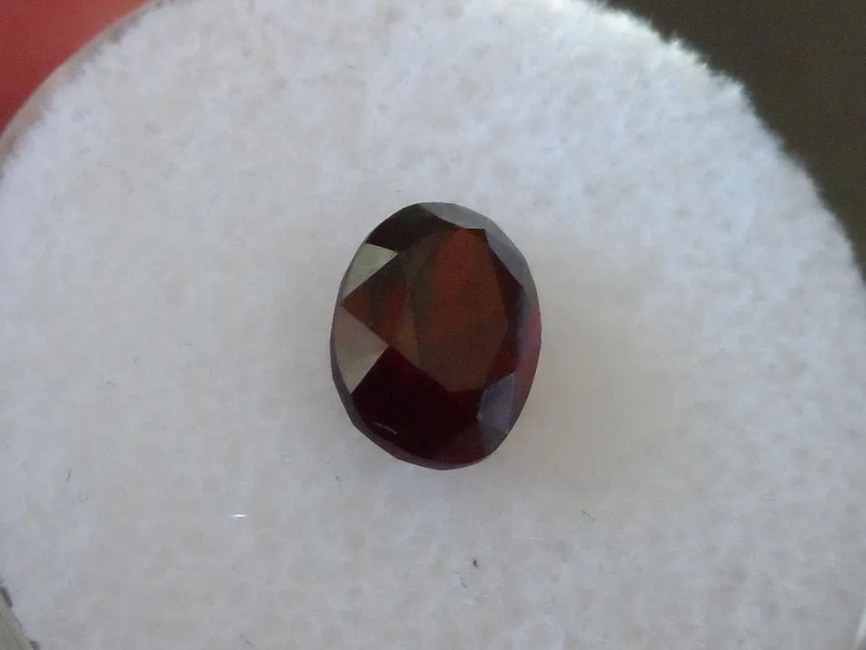 1.60 CTS. FANCY OVAL CUT DARK RED/ORANGE MONTANA GARNET